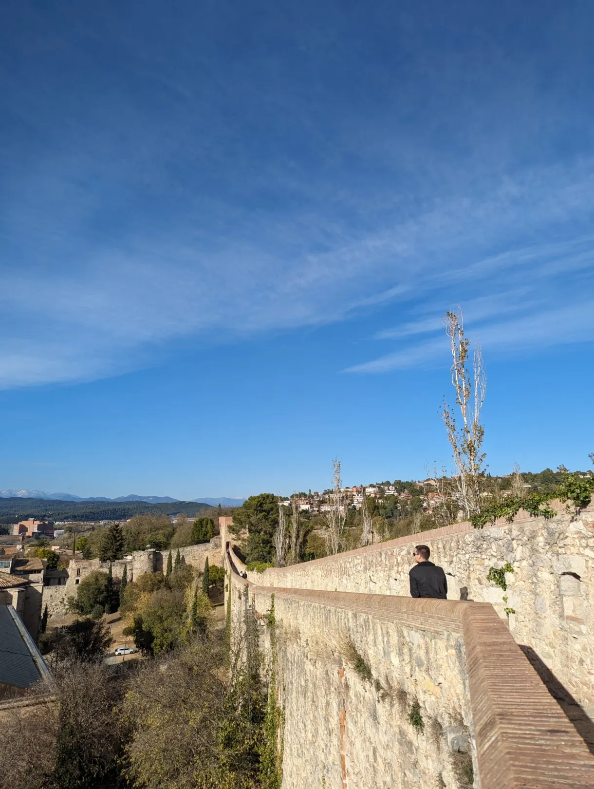 Walker on the wall walk of the ramparts, clear sky