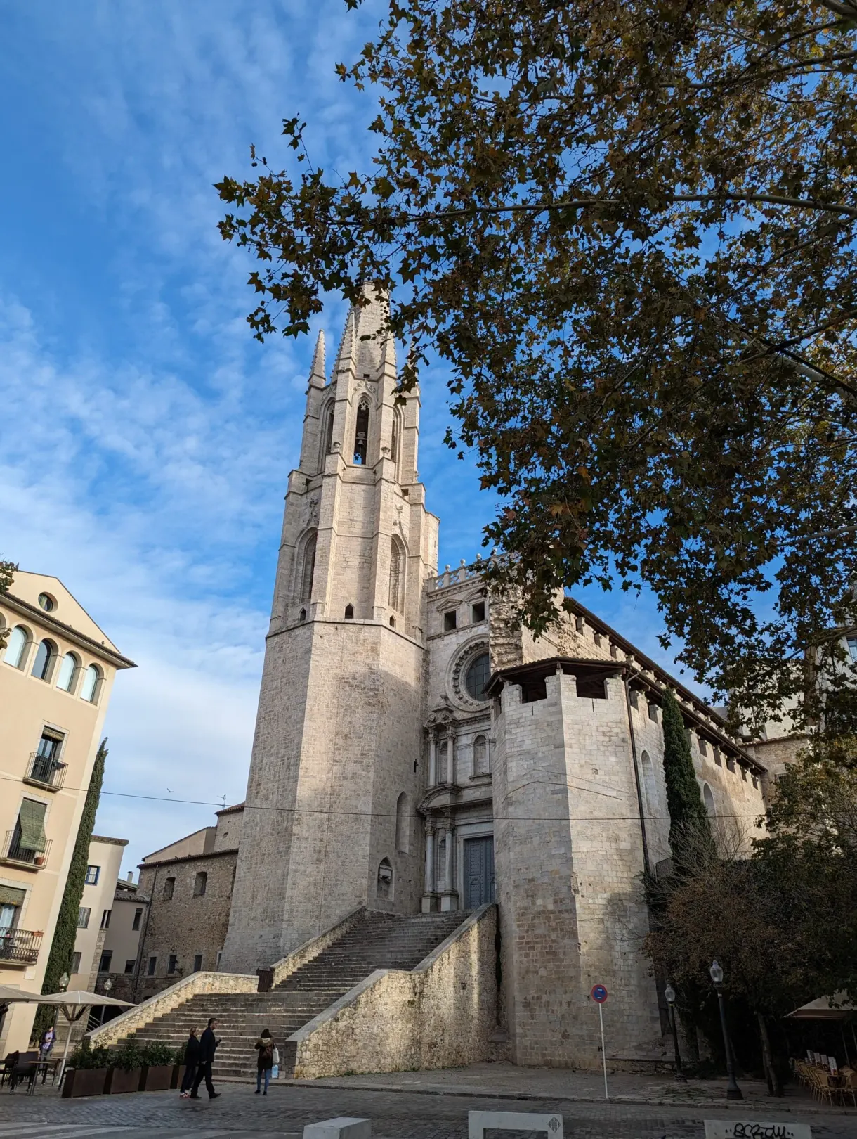 Church with a soaring Gothic bell tower and its wide entrance staircase