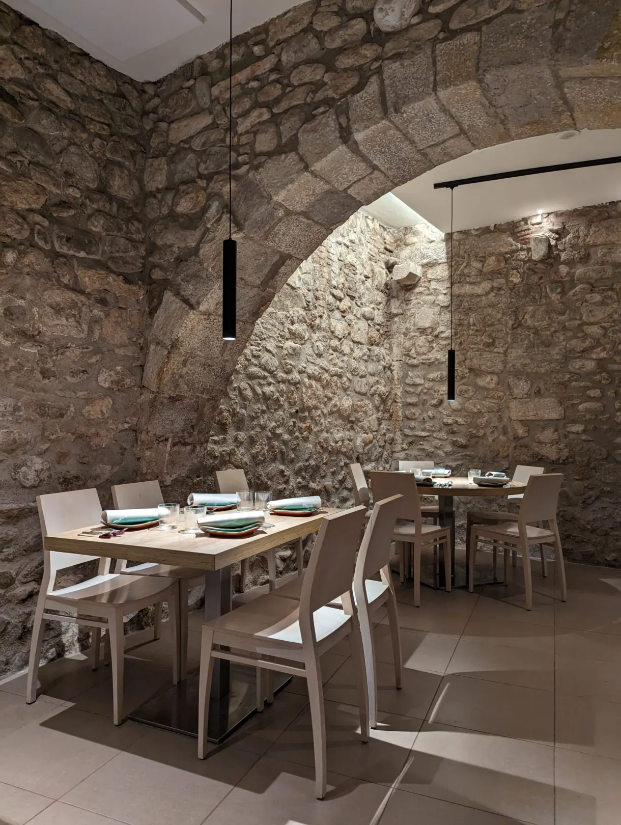 Restaurant room laid out beneath an old stone vault