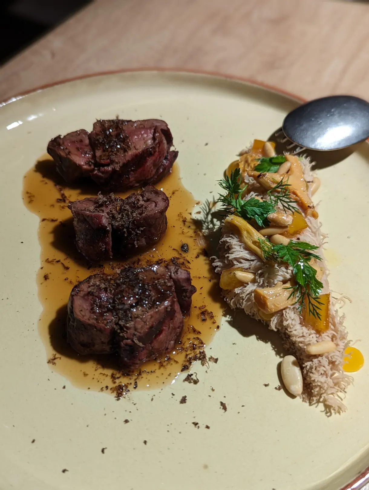 Pieces of roast meat with a garnish of mushrooms and dill