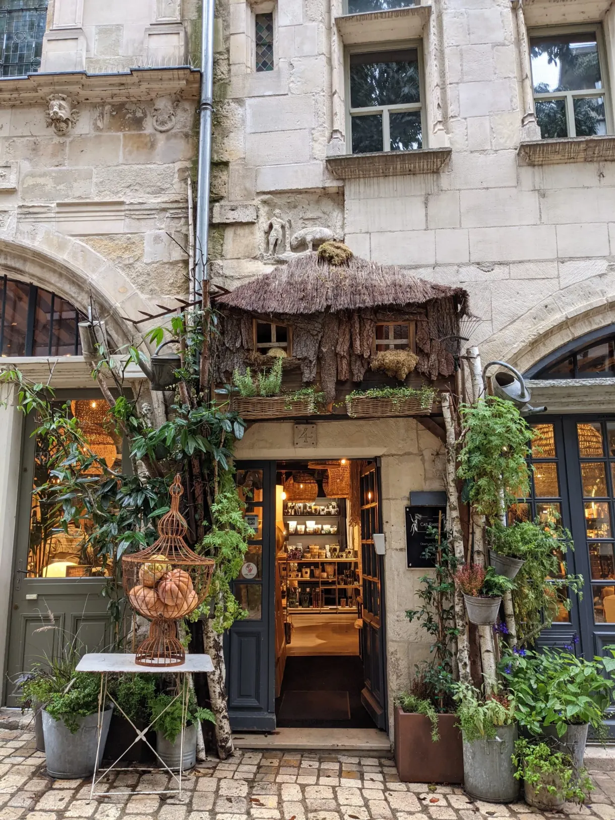 Grocery shopfront dressed with climbing plants