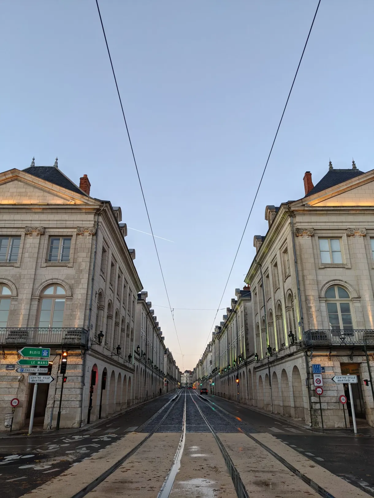 View down a straight street lined with classical buildings