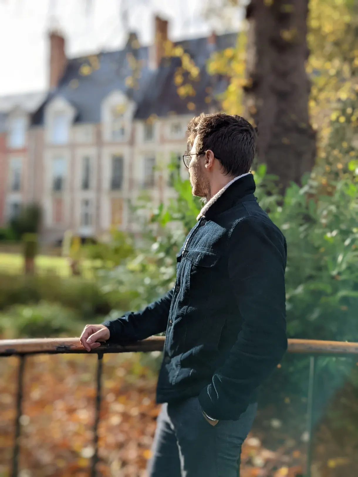 Stroller leaning on a railing in an autumn garden