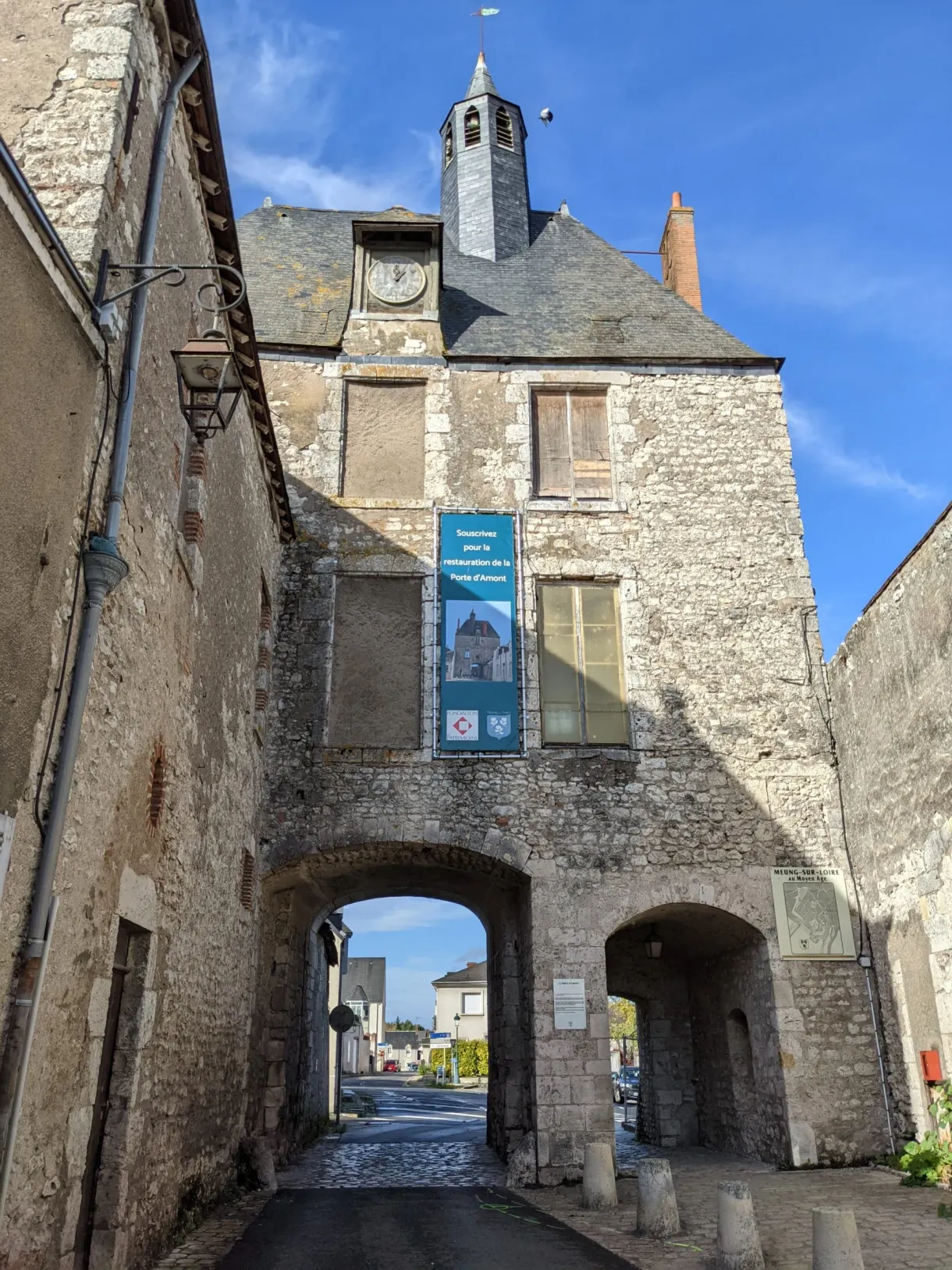 Fortified gate topped with a clock belfry