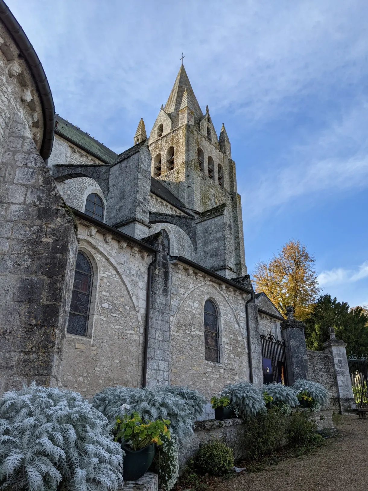 Stone apse of the church and its silvery flower beds