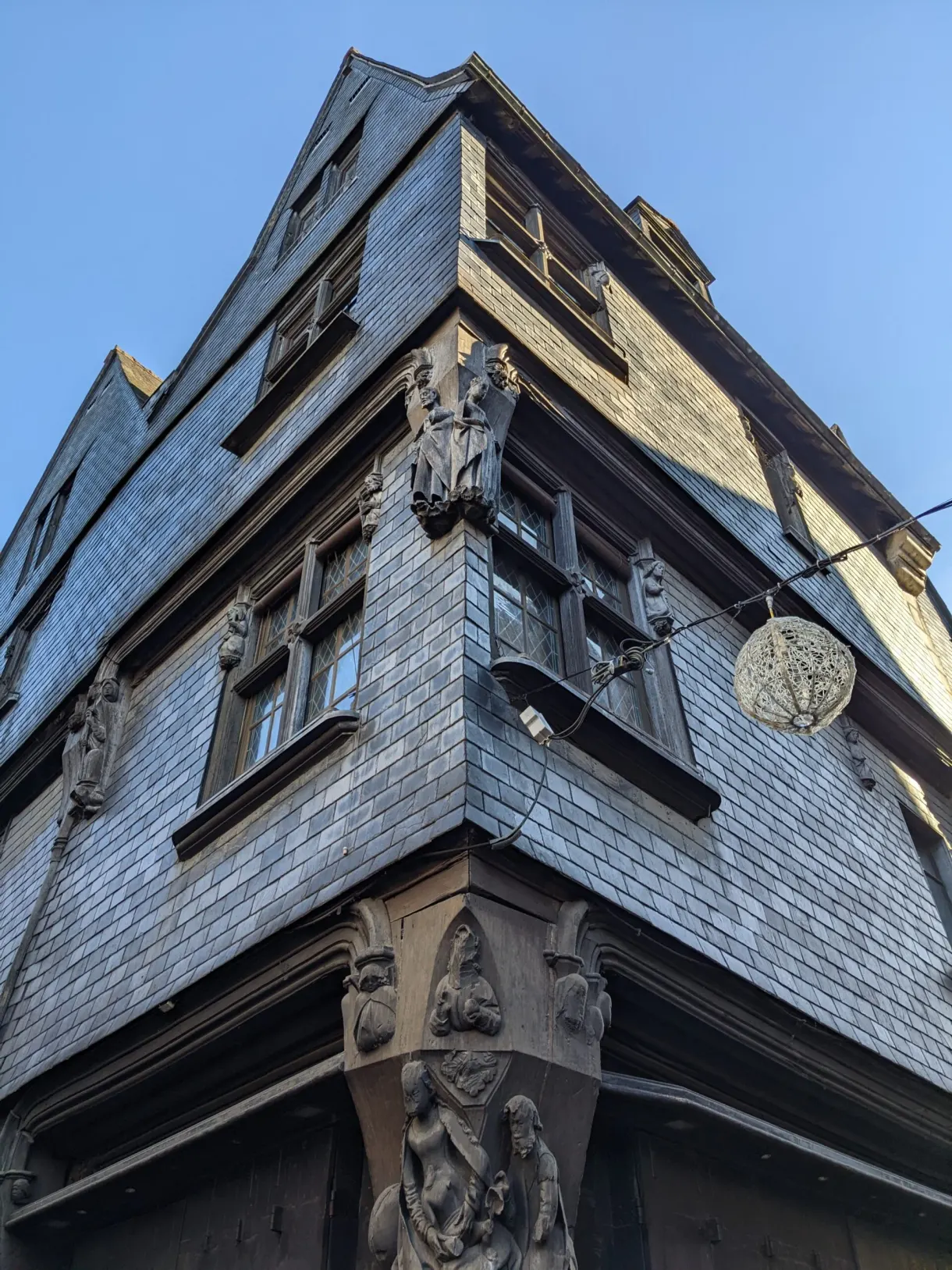Slate corbelling and carved brackets on the corner of an old house