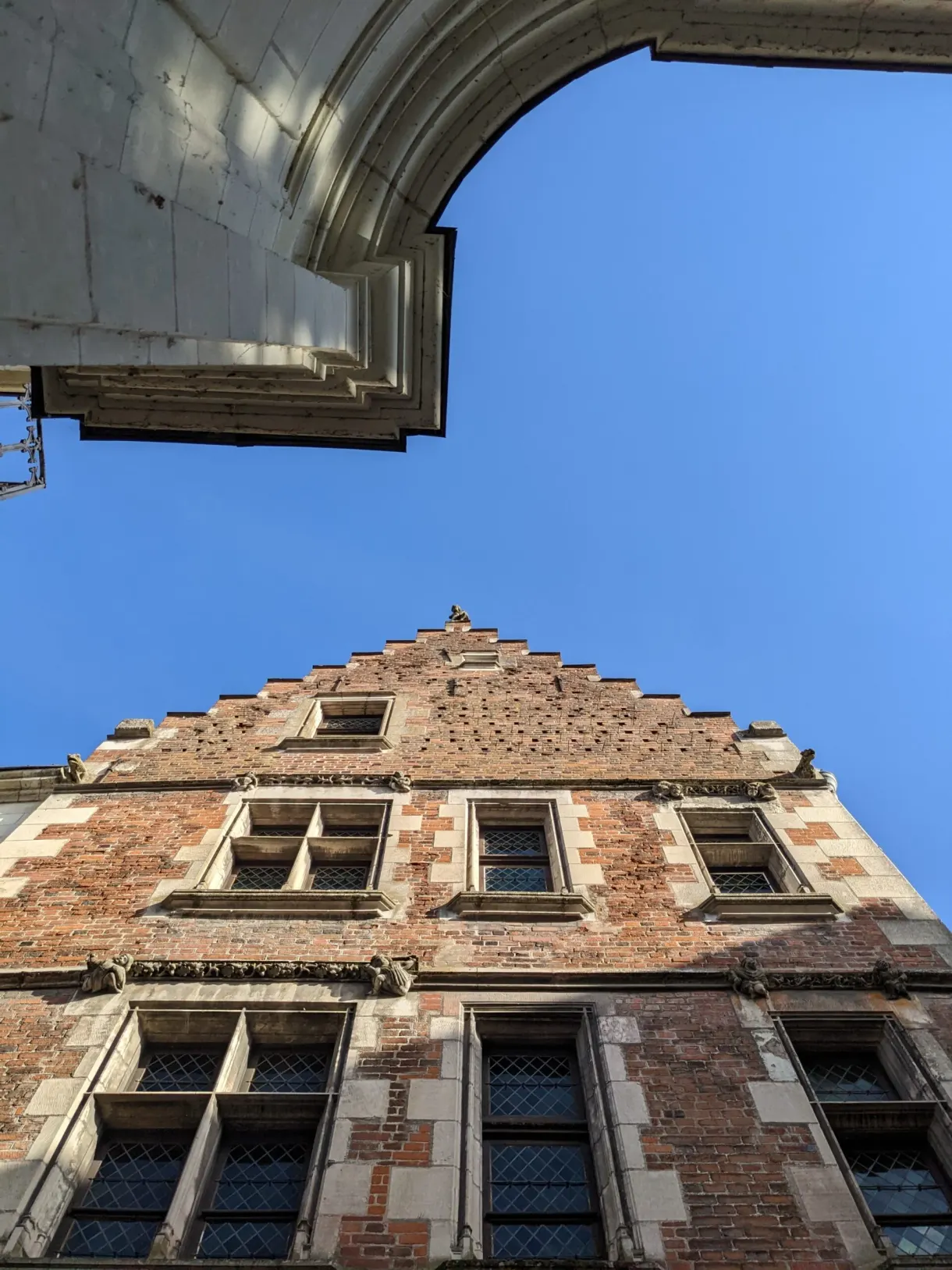 Brick and stone gable framed by a vaulted porch