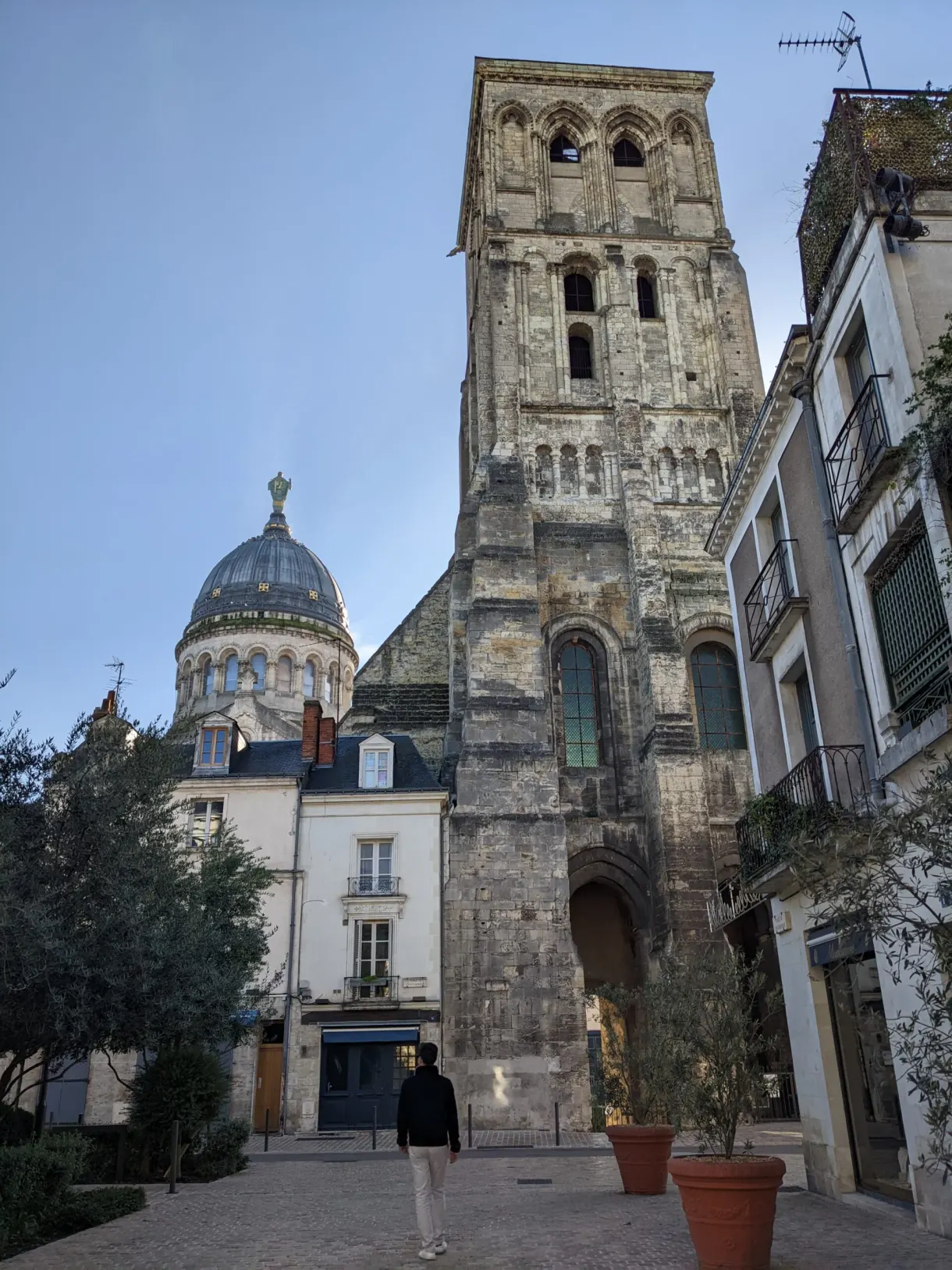Romanesque tower and blue dome at the end of a quiet little square