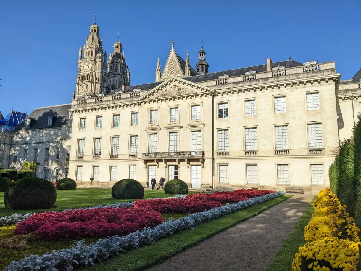 Classical palace and flower beds in front of the cathedral towers