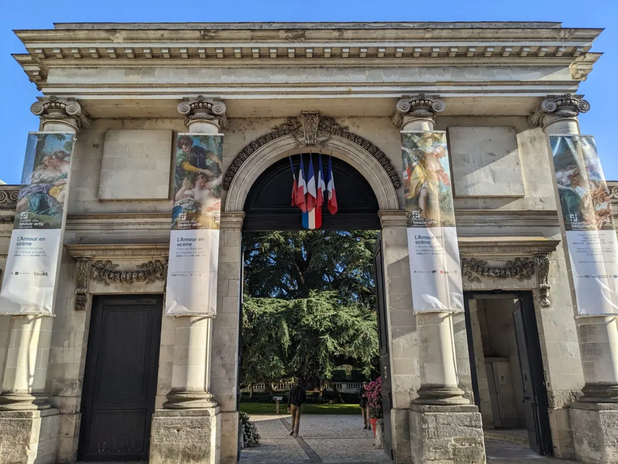 Monumental portico dressed with exhibition posters and flags