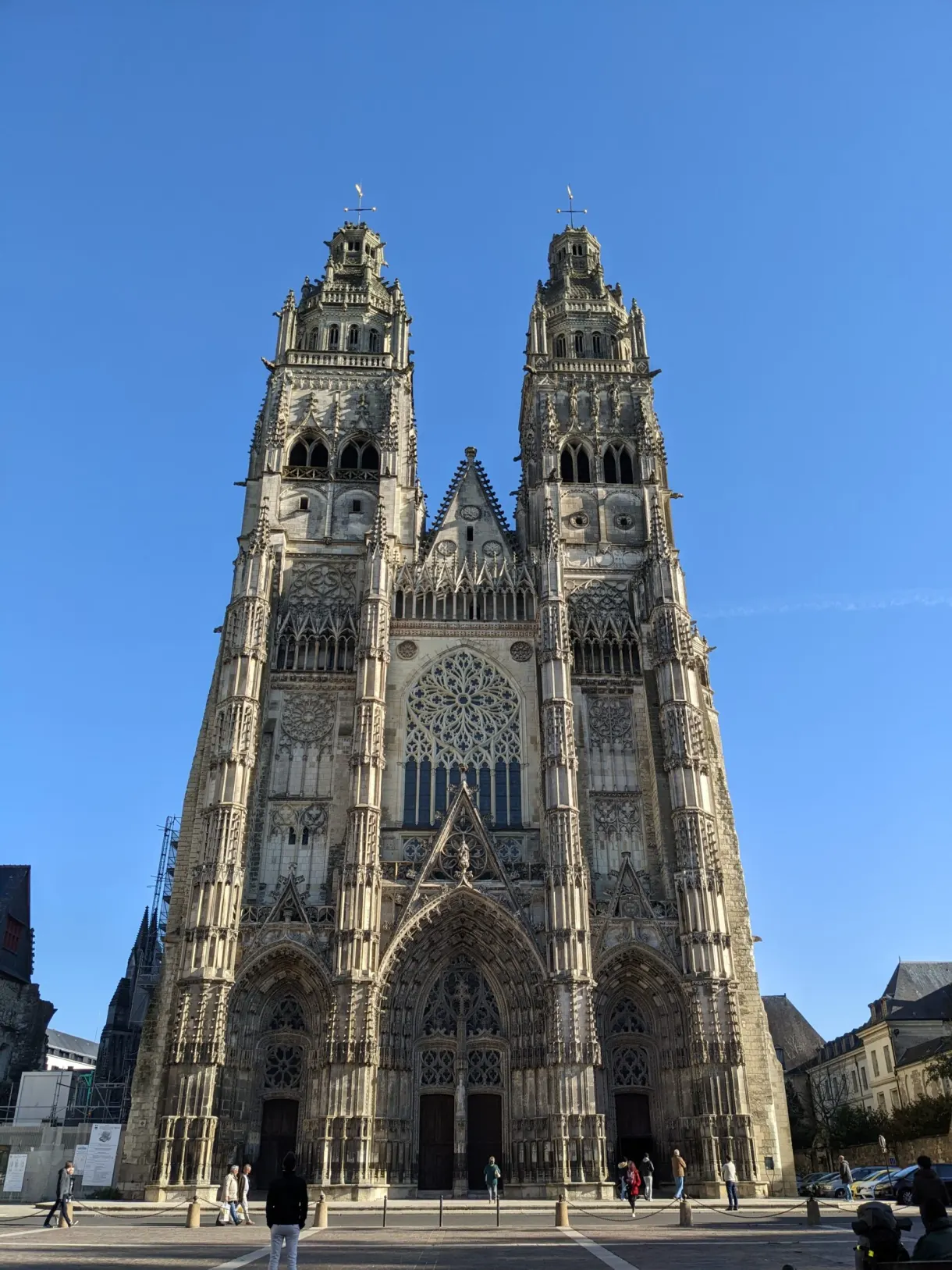 Two Gothic towers of the Saint-Gatien cathedral against the blue sky