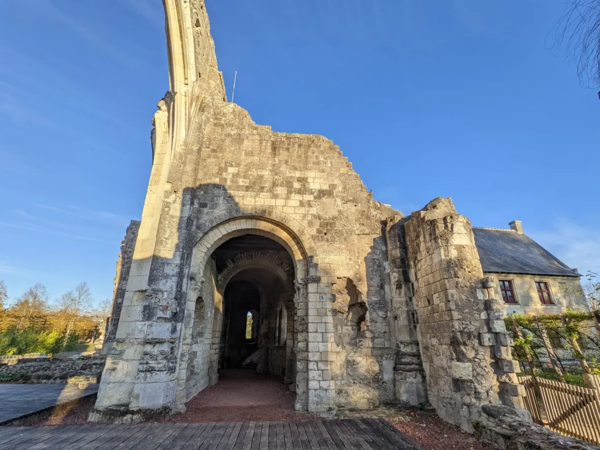 Ruined Gothic arch standing alone against the sky