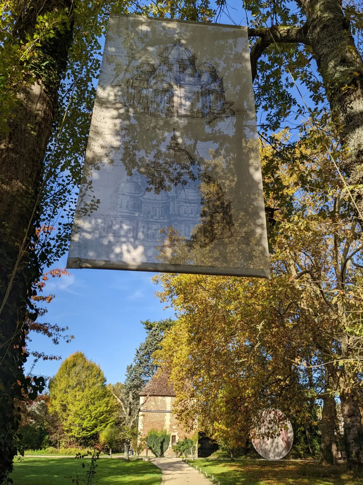 Large printed canvas hung between the trees of the park