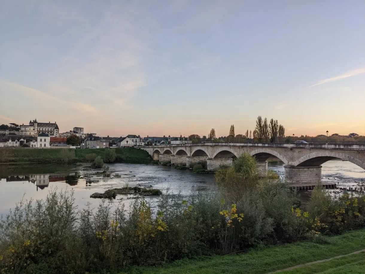 Stone bridge over the Loire at pink dusk