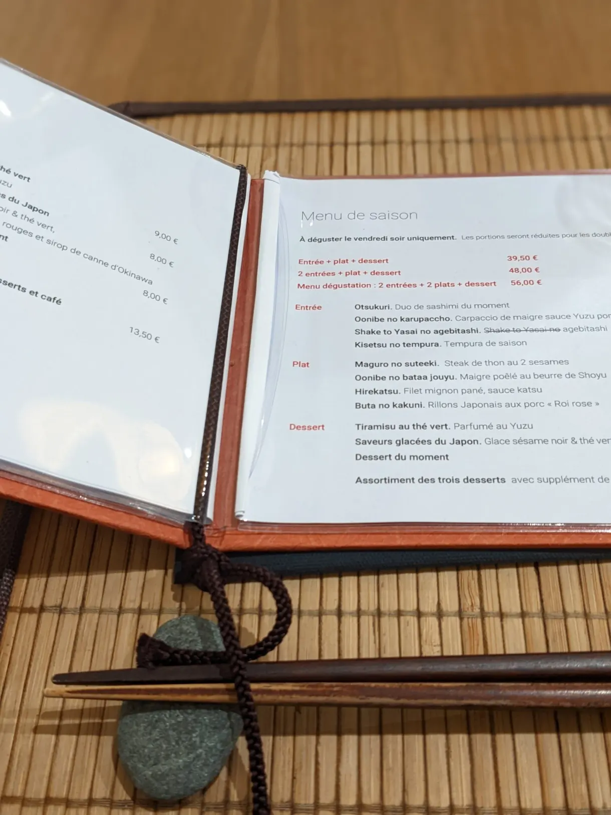 Menu open on a table laid with Japanese chopsticks