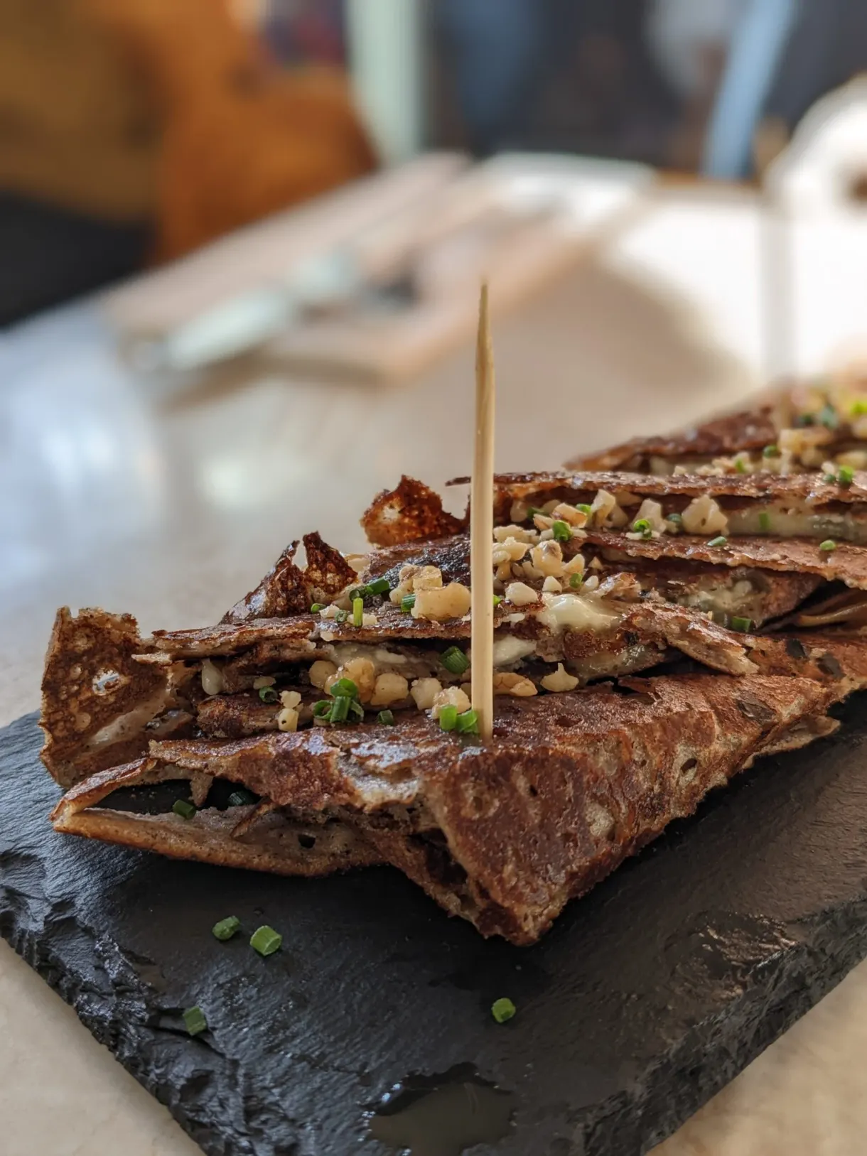 Rolled buckwheat galette skewered on a slate