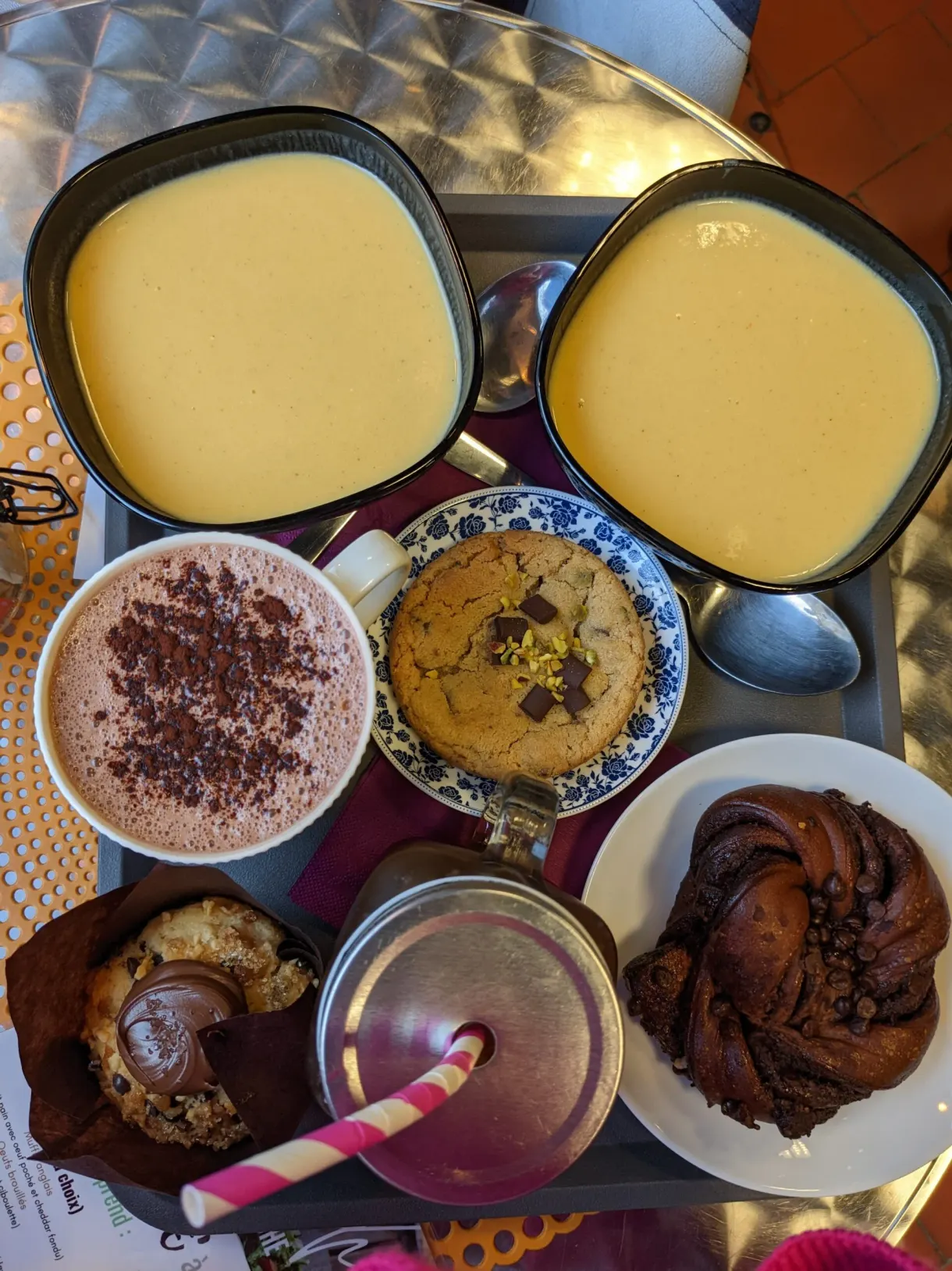Afternoon tea platter, yellow velouté shots, cappuccino and rolled brioche