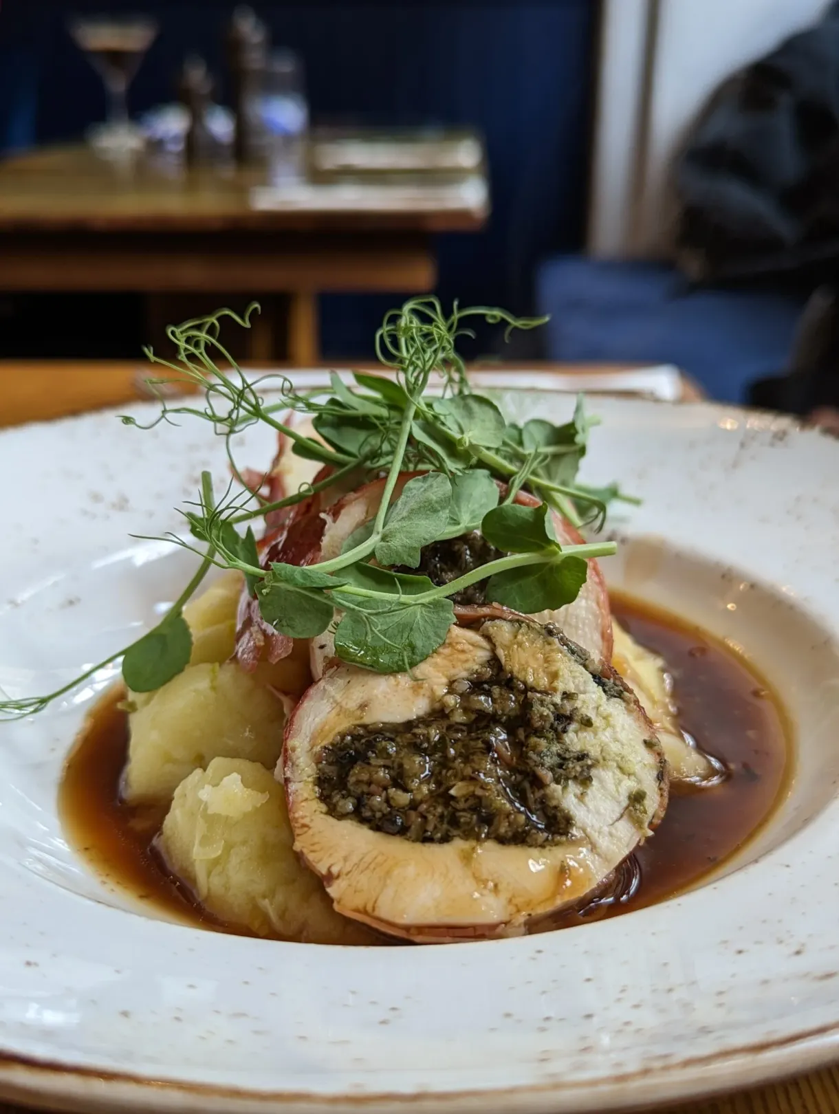 Rolled meat and mash topped with a brown jus