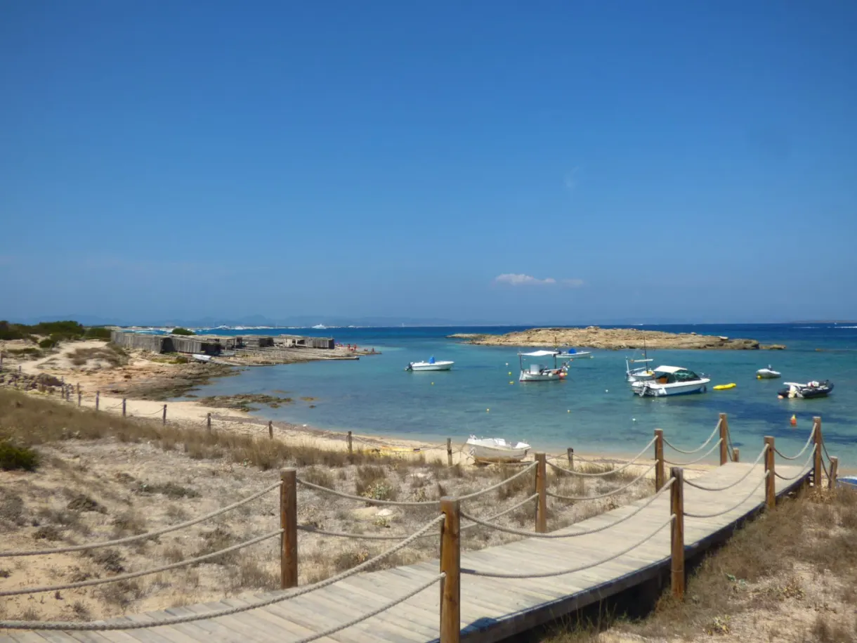 Wooden jetty leading to boats at anchor