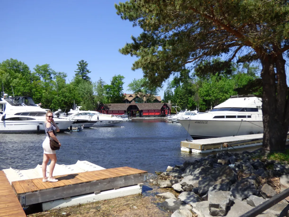 Femme sur un ponton devant les yachts de la marina