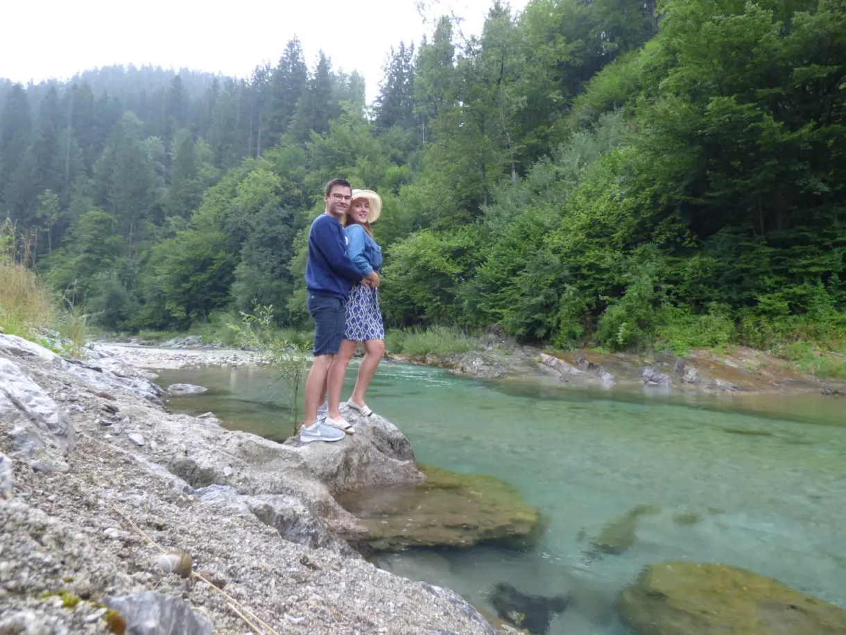 Couple embracing on a rock beside the river