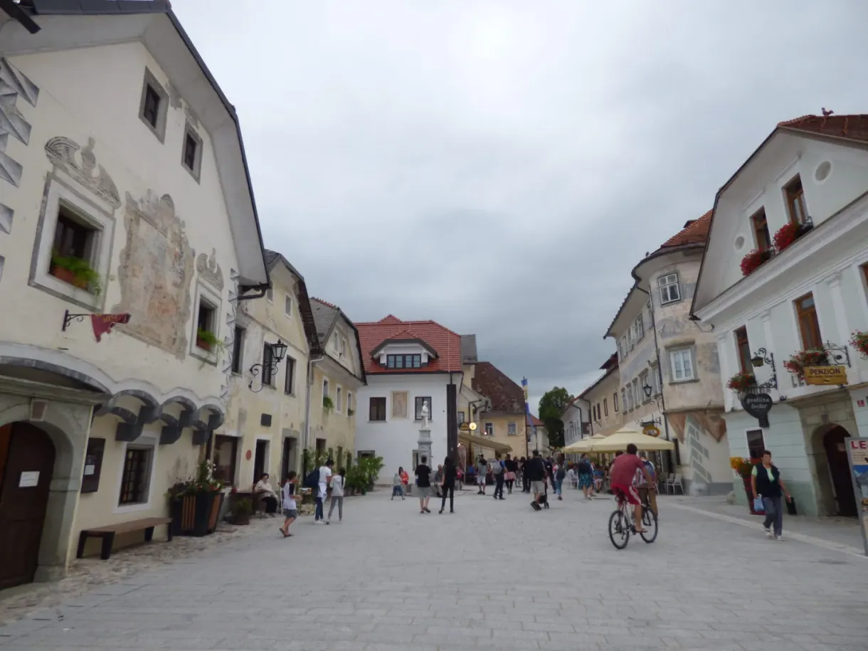 Lively old street lined with frescoed houses