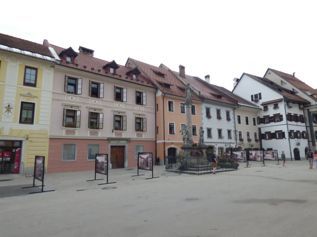 Square lined with pastel houses and its column