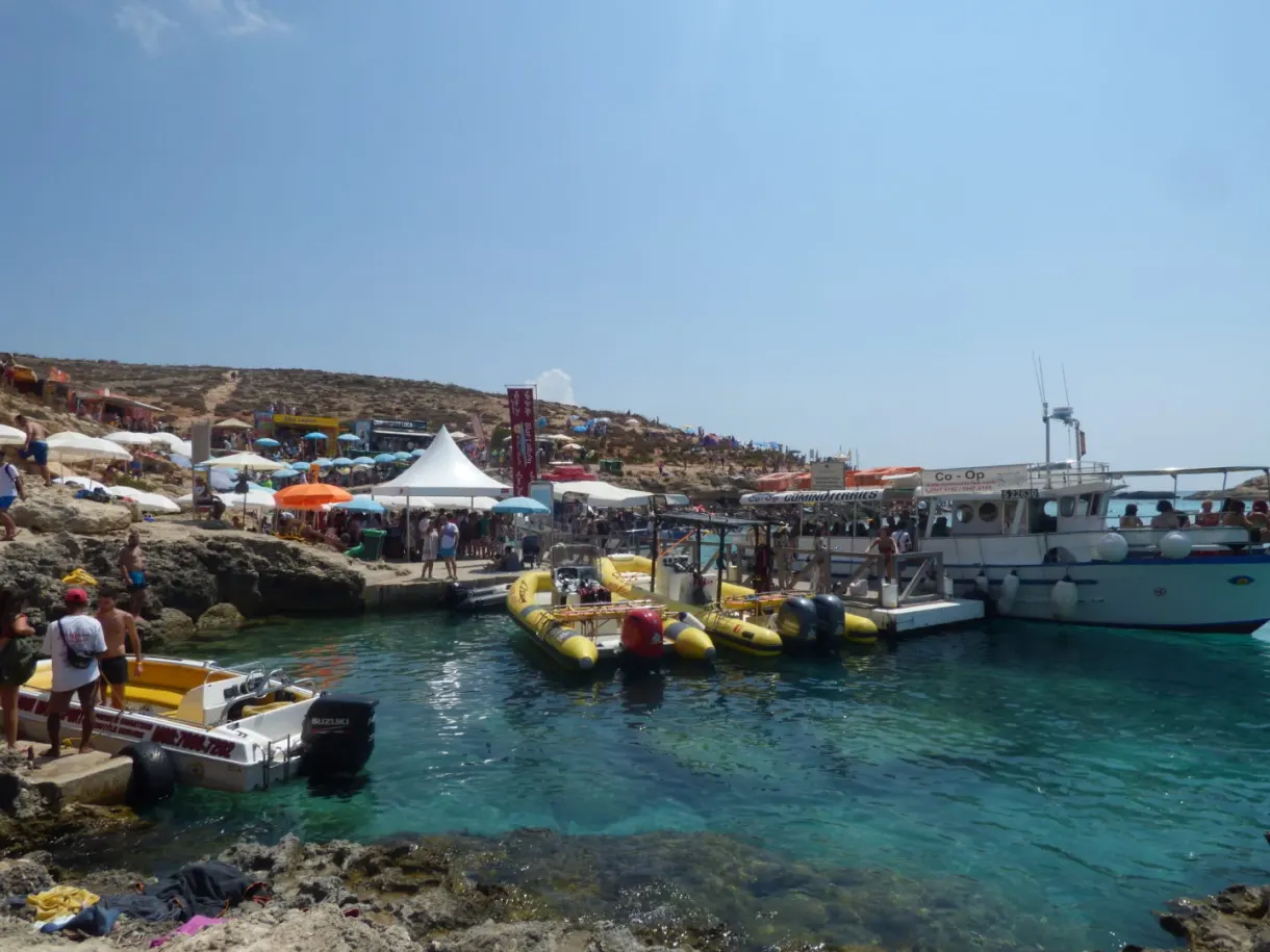 Boats and colourful stalls packed along the quay