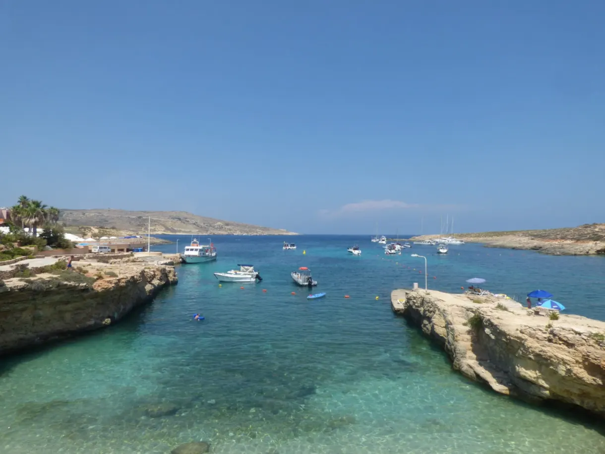 Boats anchored in a cove with crystal clear water