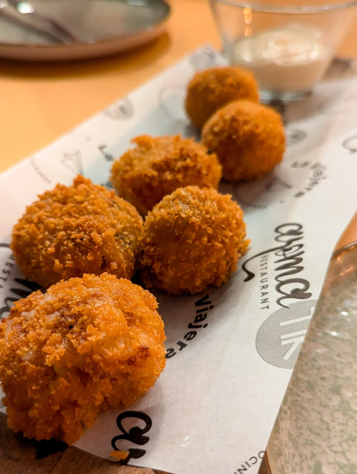 Golden breaded croquettes served on paper