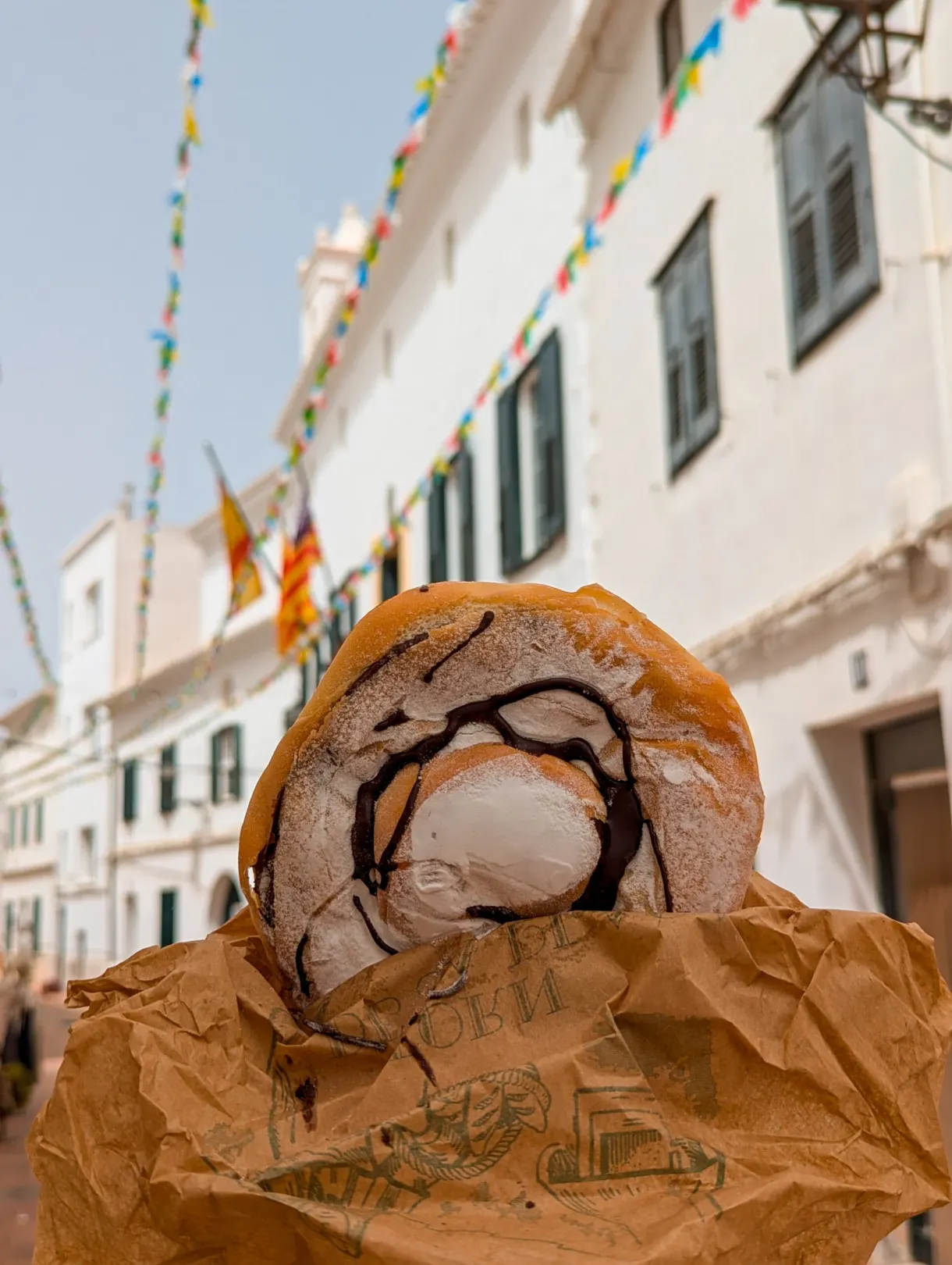 Chocolate pastry held in a white lane