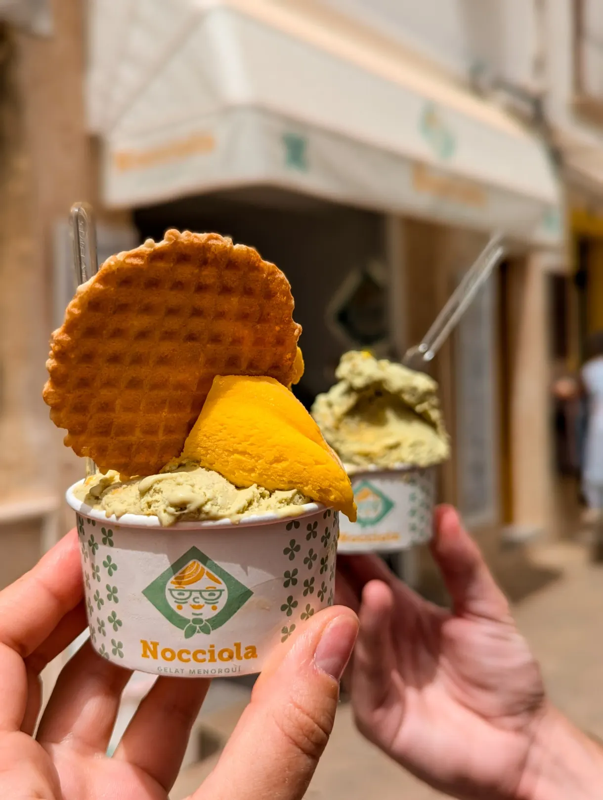 Pistachio and mango ice creams topped with a wafer