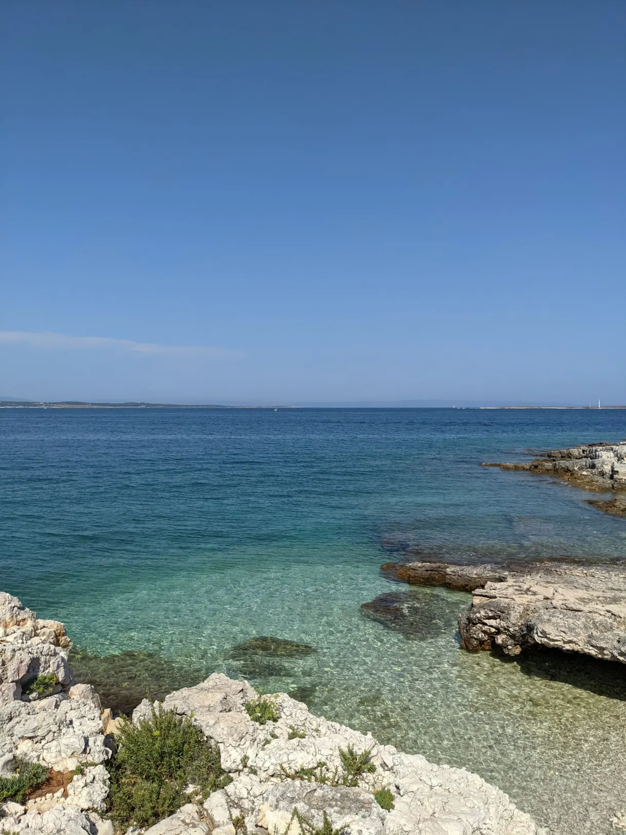 Clear turquoise water over the rocky slabs of Kamenjak