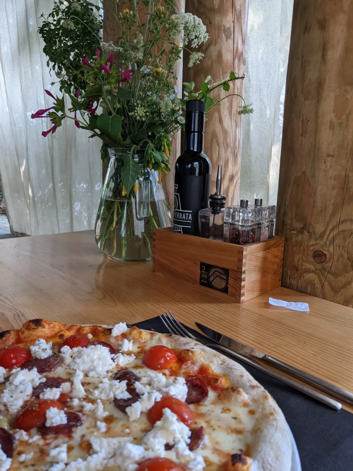 Pizza with cherry tomatoes and fresh cheese served at the konoba 2.Peron