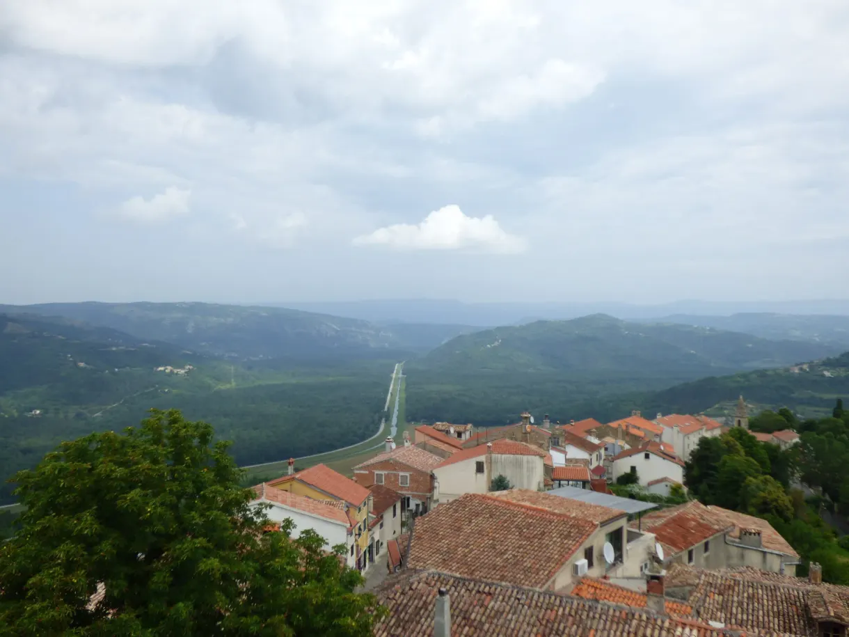 Tiled roofs and wooded valley seen from the ramparts of Motovun