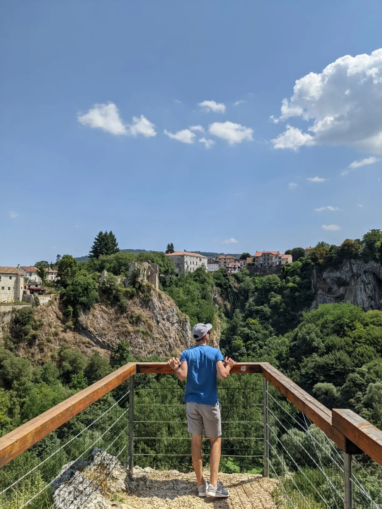 Man leaning on the walkway of the viewpoint above the Pazin chasm