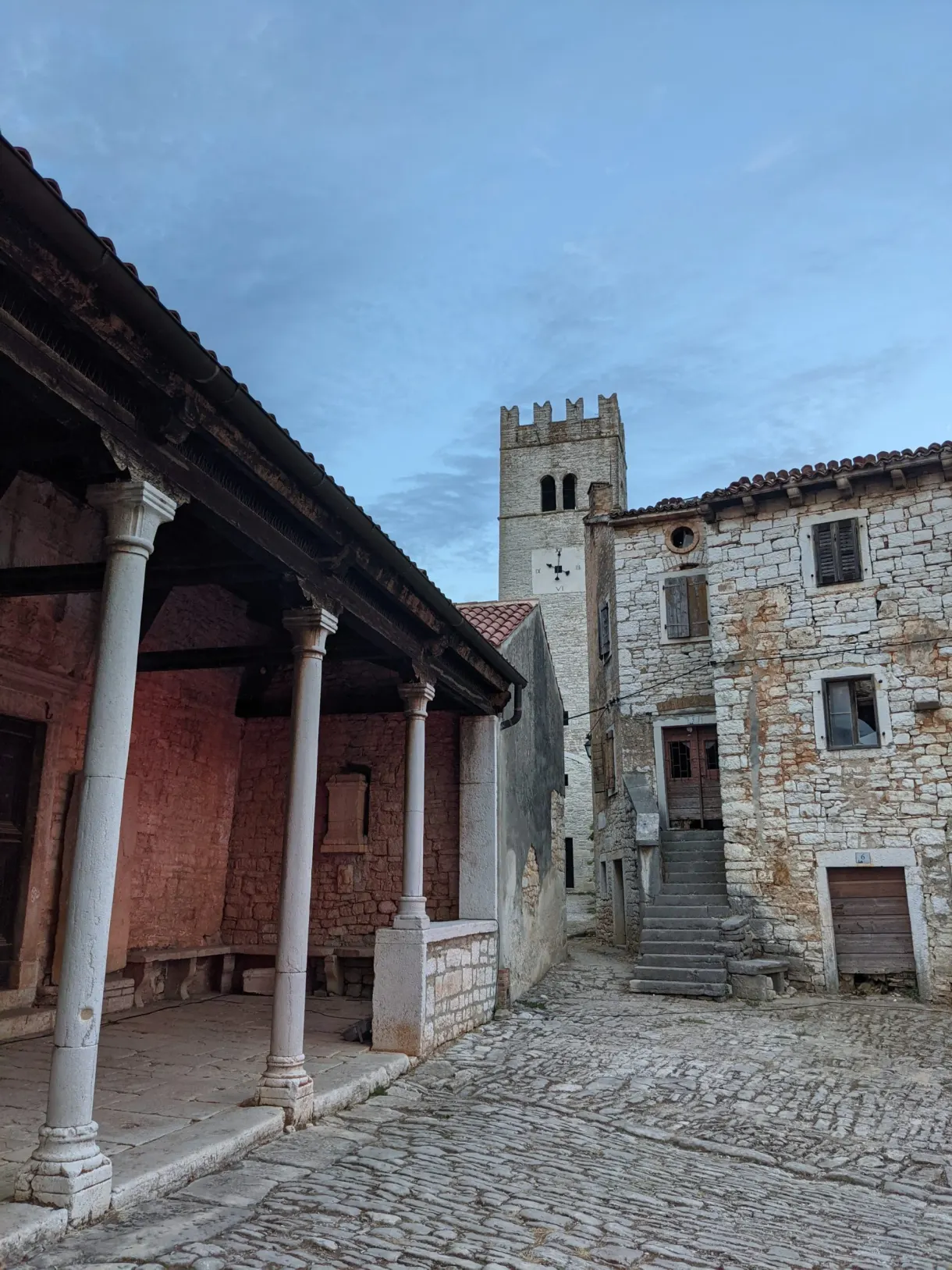 Colonnaded loggia and crenellated tower on the square of Sveti Lovreč