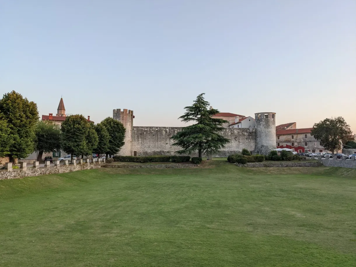 Vast lawn in front of the crenellated ramparts of Svetvinčenat castle