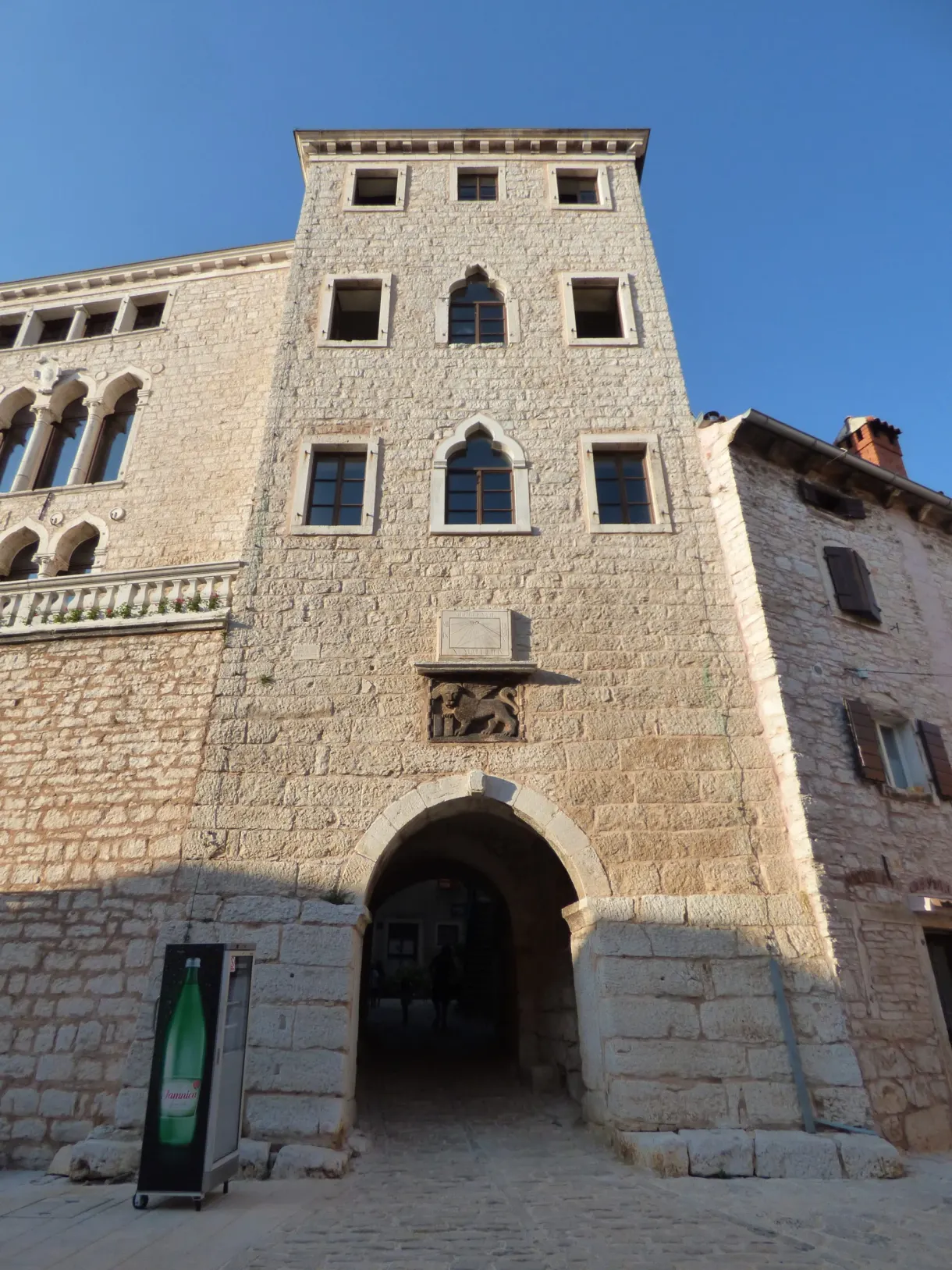 Gothic palace with mullioned windows on the square of Bale