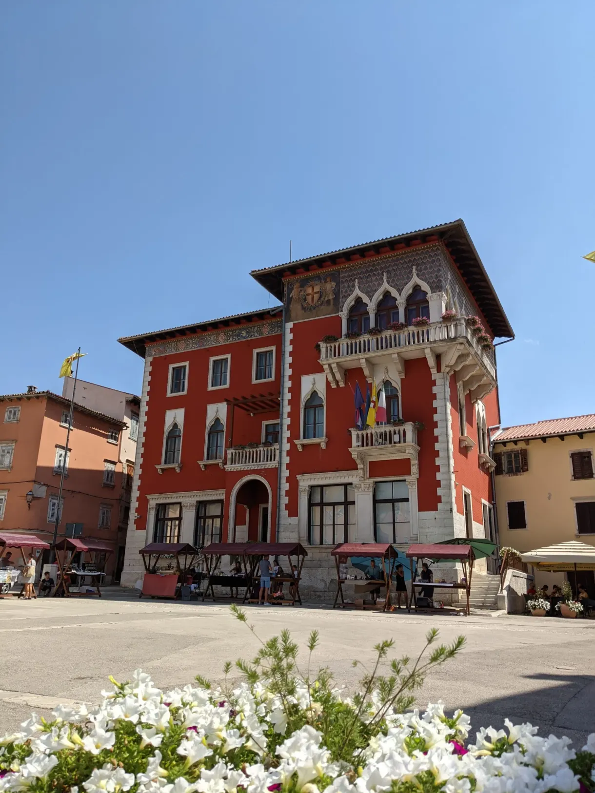 Red palace with neo-gothic decoration on the main square of Vodnjan