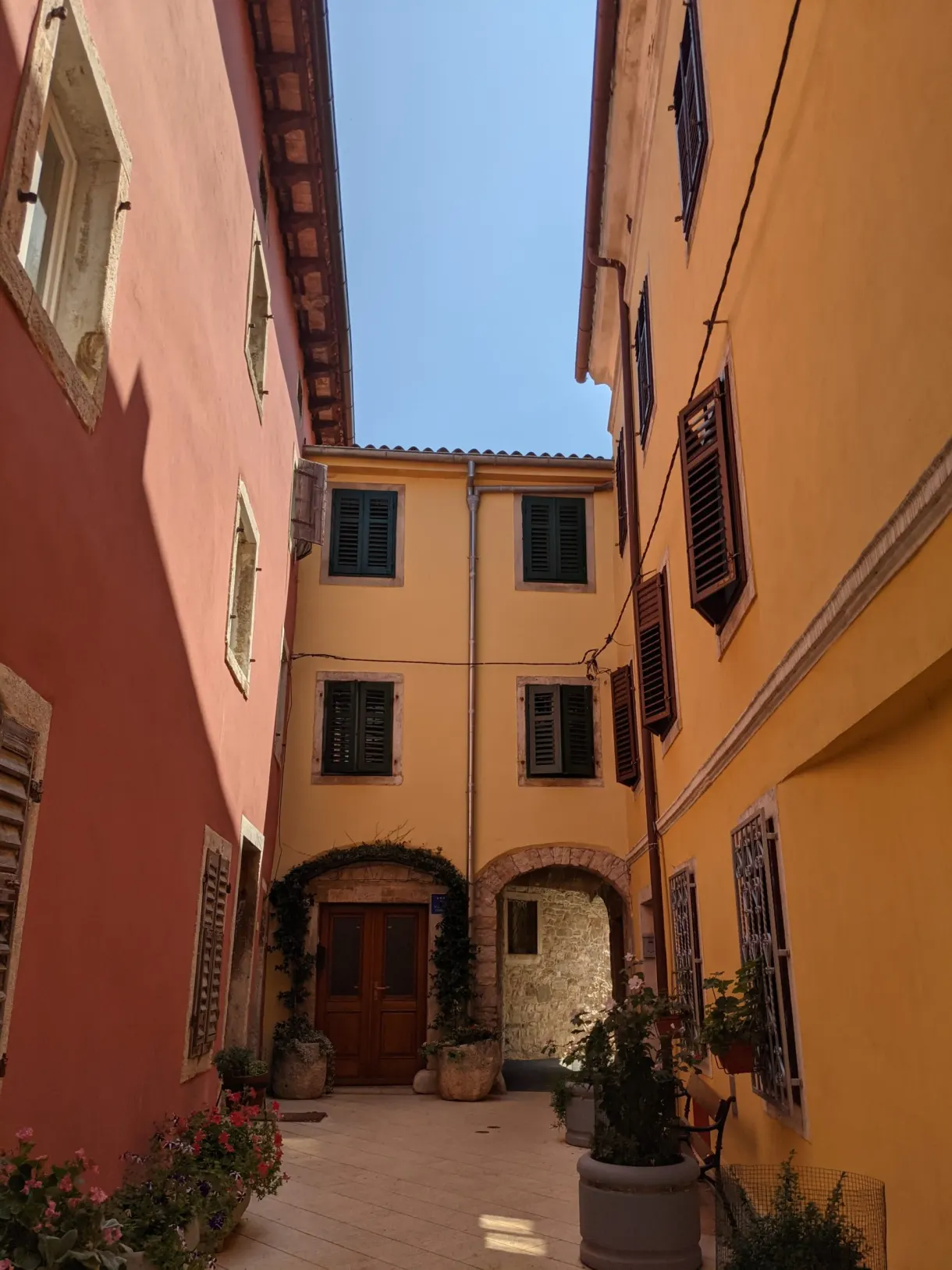 Courtyard with ochre and orange façades in old Vodnjan