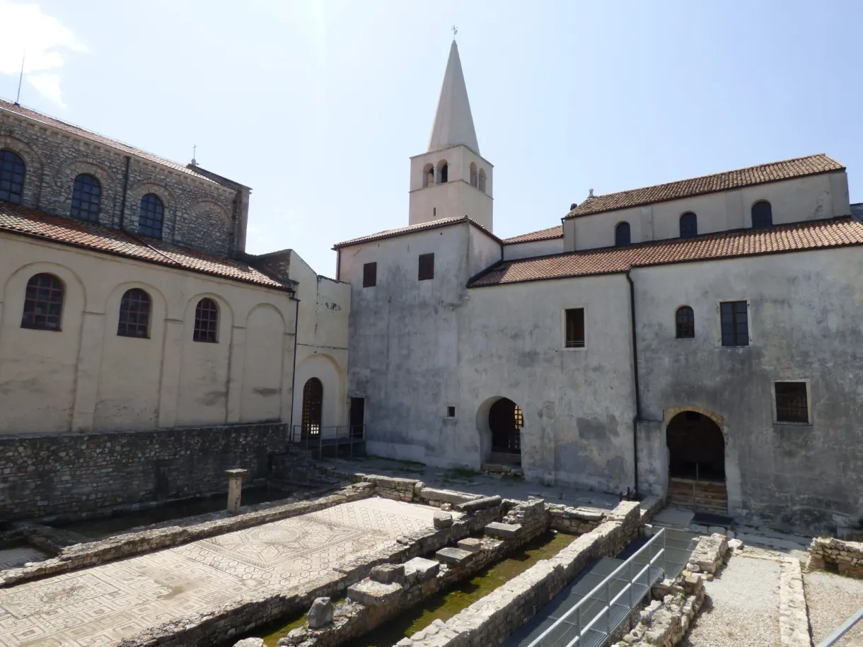 White bell tower and excavated remains of the episcopal complex of Poreč