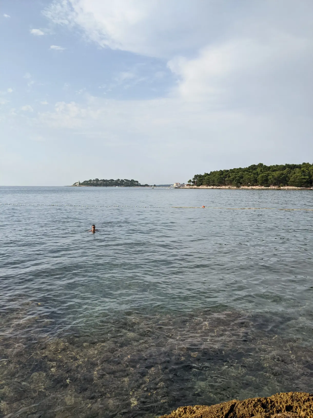 Transparent sea and wooded islet off the Plava Laguna