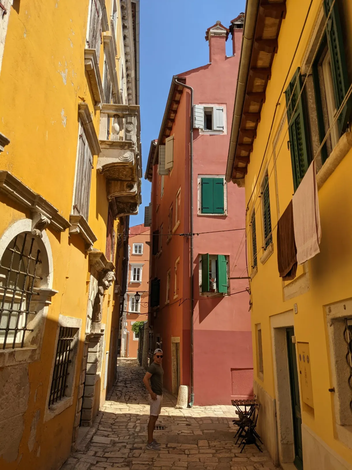 Lane with yellow, pink and ochre façades in old Rovinj