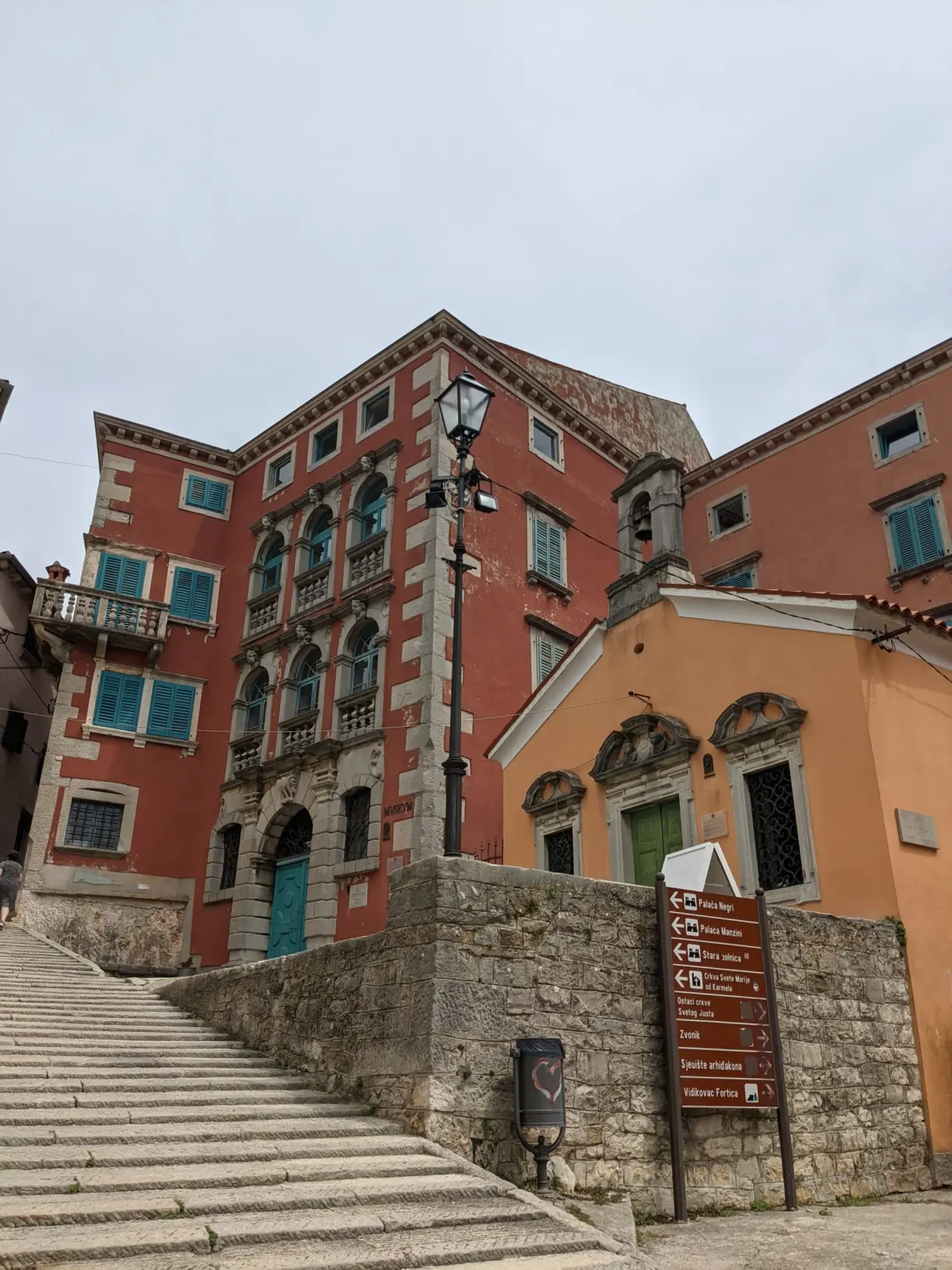 Red palace and wide stone staircase in the old town of Labin