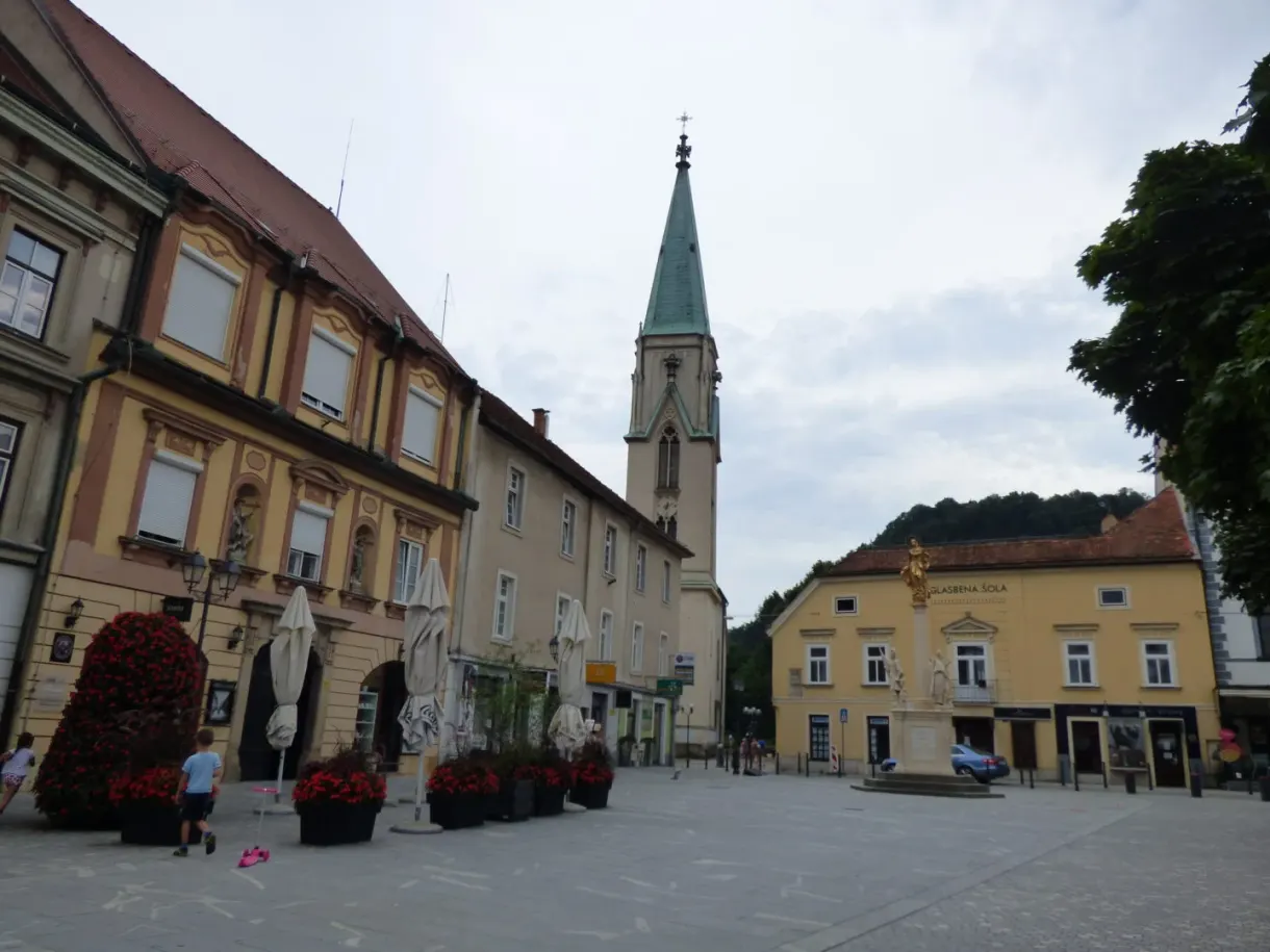Cobbled central square lined with yellow facades and a bell tower
