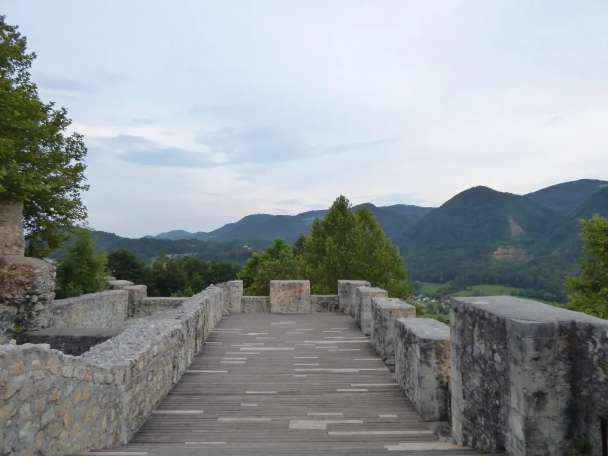 Stone walkway between two low walls facing the mountains