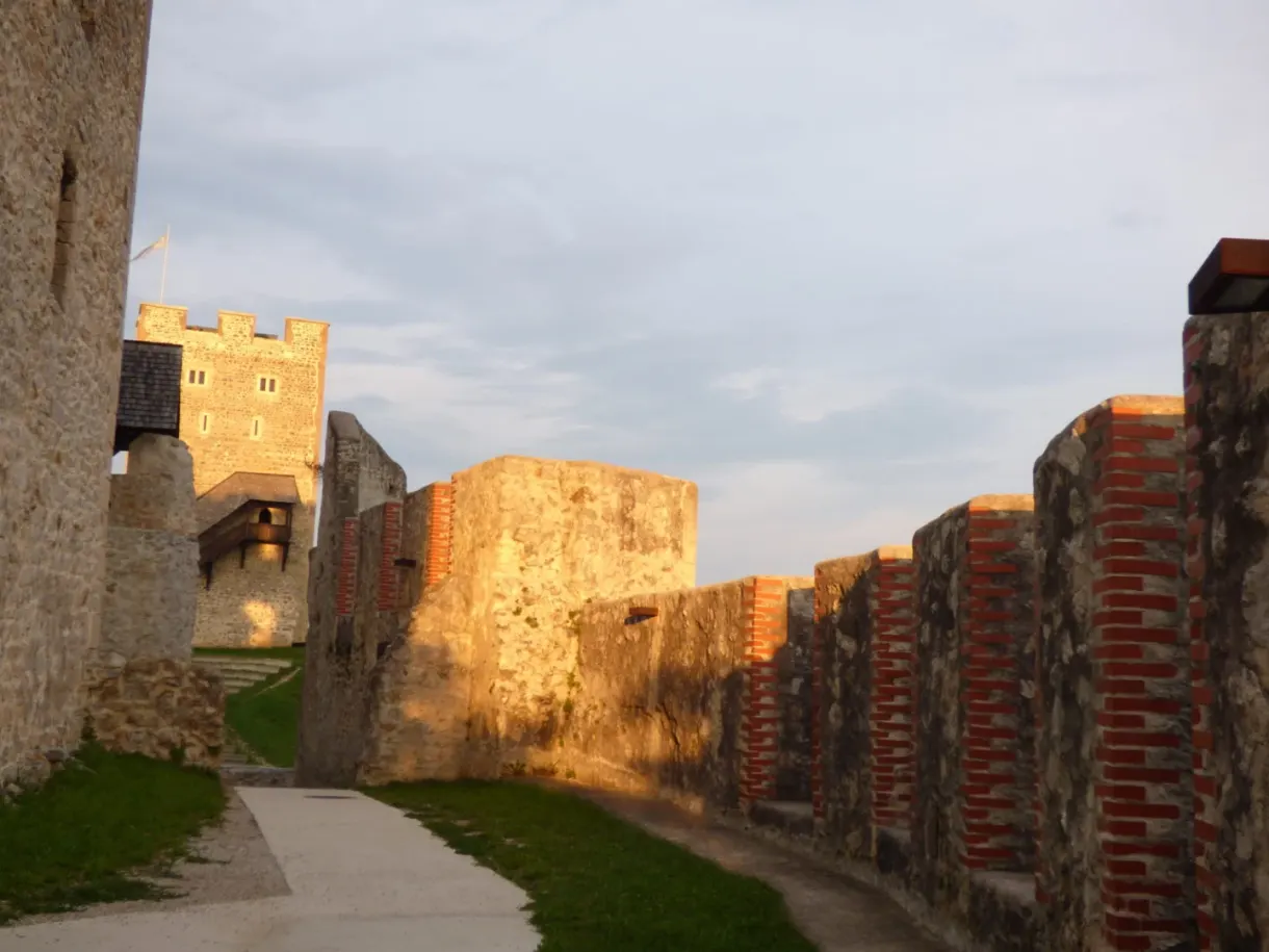 Wall turned golden by the low sun along the path