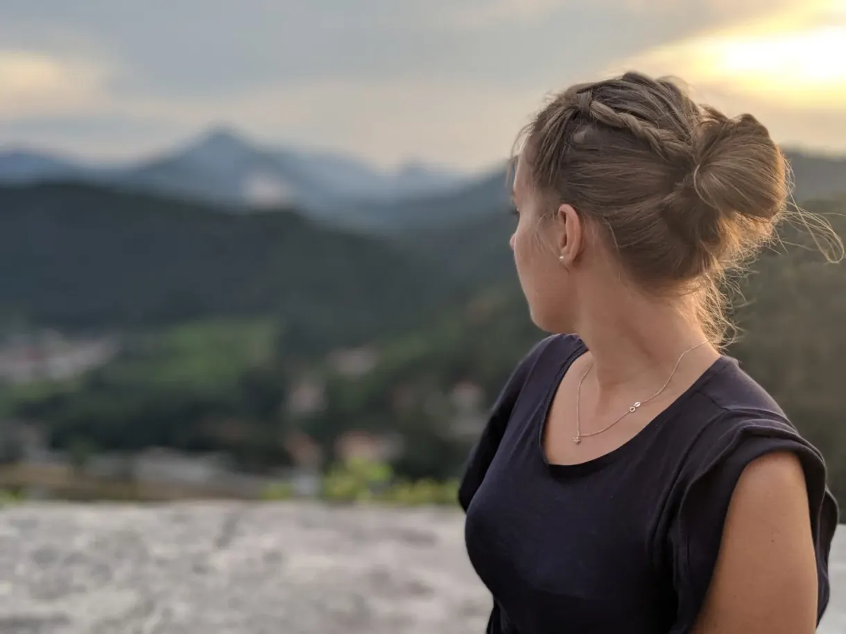 Woman in profile looking at the mountains from the rampart