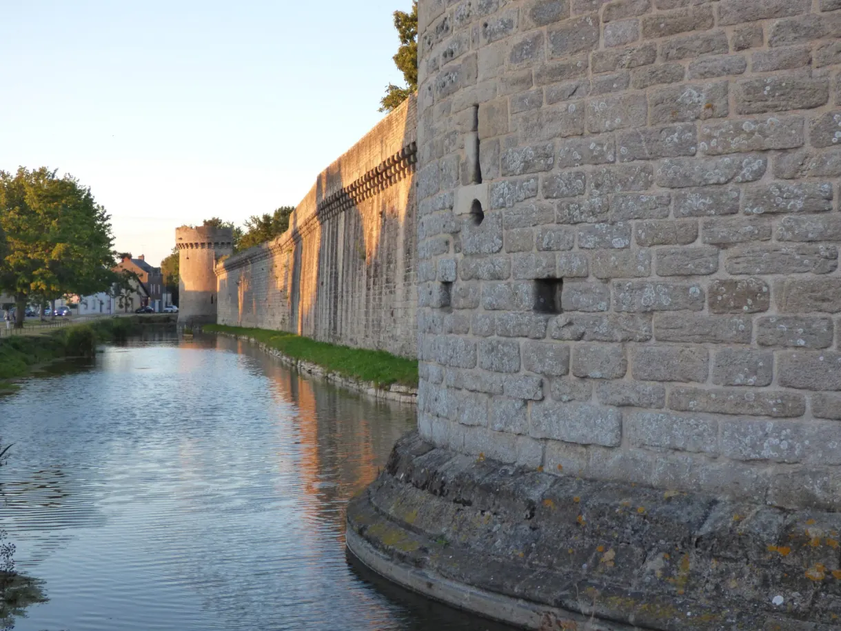 Water-filled moat at the foot of the granite wall